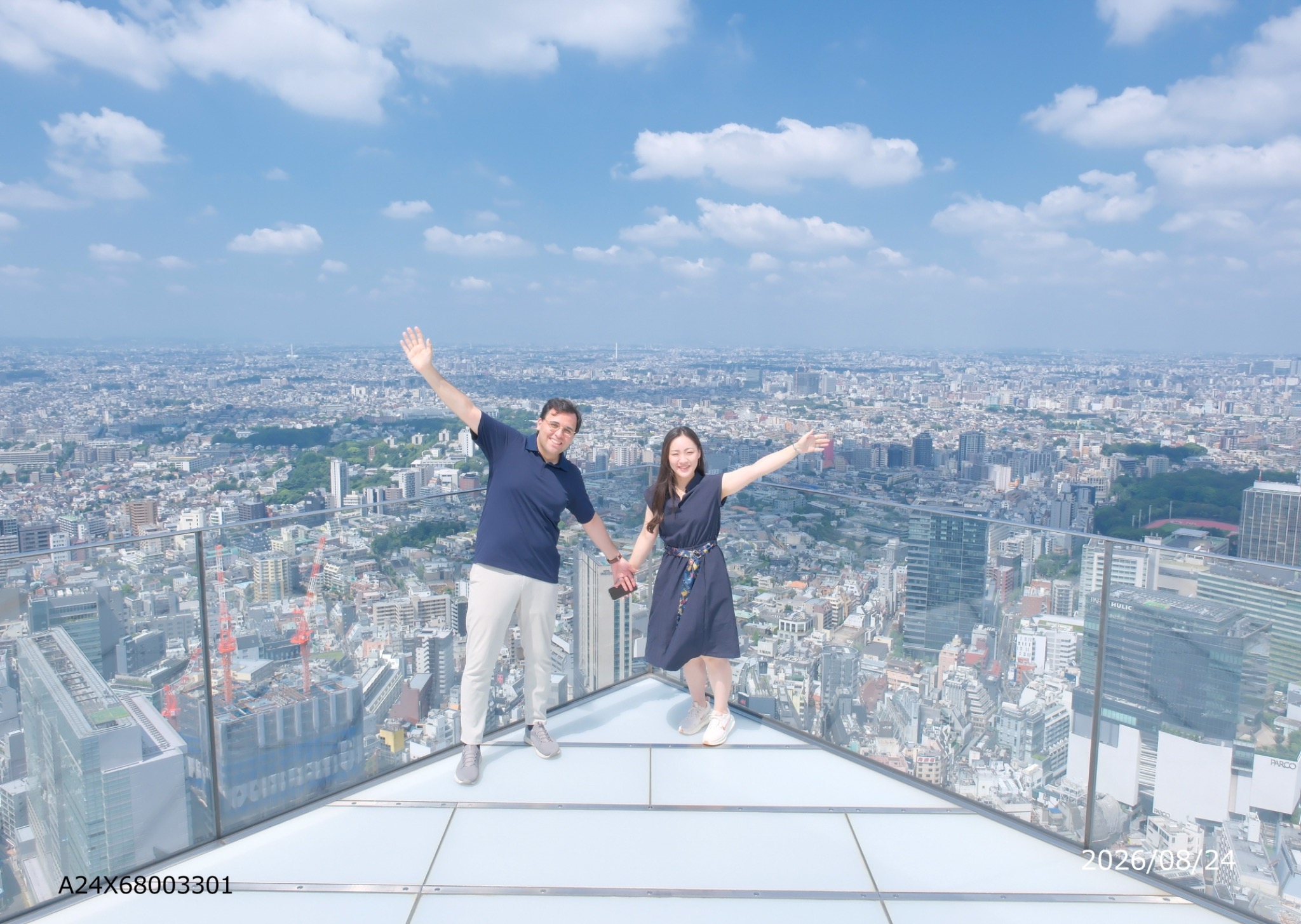 Oveis and Yuri holding hands above the Tokyo skyline